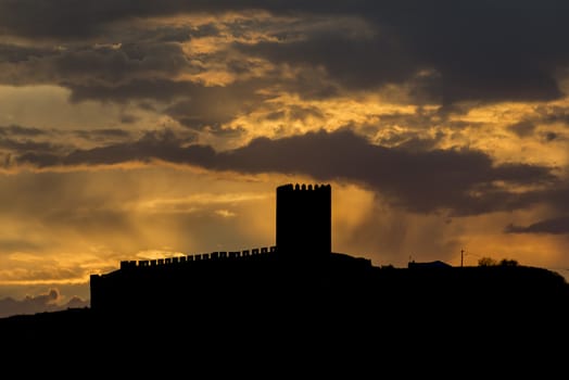 sunrays from the clouds over the catle of portel in portugal