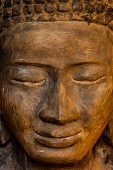 Face front of stone Buddha seen in a temple in Angkor Wat