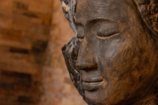 Face front of stone Buddha seen in a temple in Angkor Wat