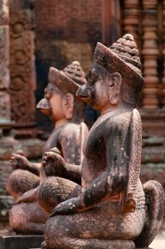 Stone sculputure sitting in front of temple Banteay Srei Angkor Wat