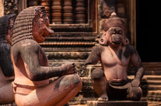 Stone sculputure sitting in front of temple Banteay Srei Angkor Wat