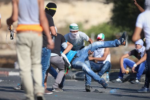 WEST BANK, Ramallah: Young masked Palestinians are seen in a street of northern Ramallah, West Bank, on October 17, 2015, during clashes with Israeli army near Beit El Israeli settlement.