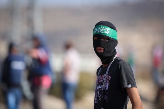 WEST BANK, Ramallah: A young masked Palestinian is seen in a street of northern Ramallah, West Bank, on October 17, 2015, during clashes with Israeli army near Beit El Israeli settlement.