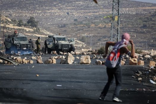 WEST BANK, Ramallah: A young masked Palestinian with a sling-shot is seen in a street of northern Ramallah, West Bank, on October 17, 2015, during clashes with Israeli army near Beit El Israeli settlement.