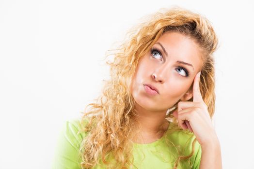 Portrait of beautiful young woman thinking and looking up. Close-up with white background.