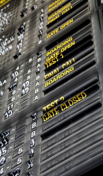 Airport departure board in terminal with flight information