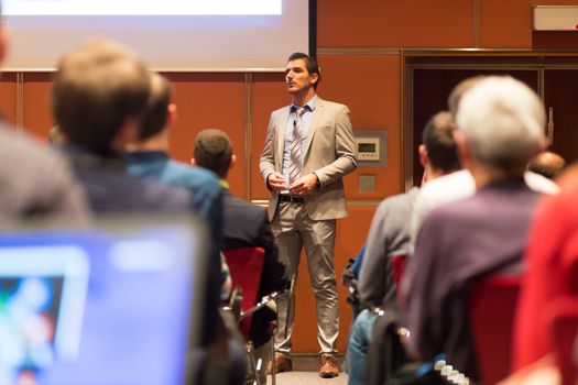 Speaker Giving a Talk at Business Meeting. Audience in the conference hall. Business and Entrepreneurship concept.