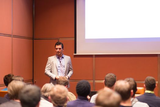 Speaker Giving a Talk at Business Meeting. Audience in the conference hall. Business and Entrepreneurship concept.