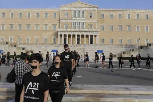 GREECE, Athens: Athens residents walk past Greek parliament while participating in the Walk for Freedom, a global initiative against human trafficking by the A21 Campaign, on October 17, 2015. The walk was one of several held worldwide by the organisation, which aims to raise awareness of human trafficking and provide support to survivors.  	