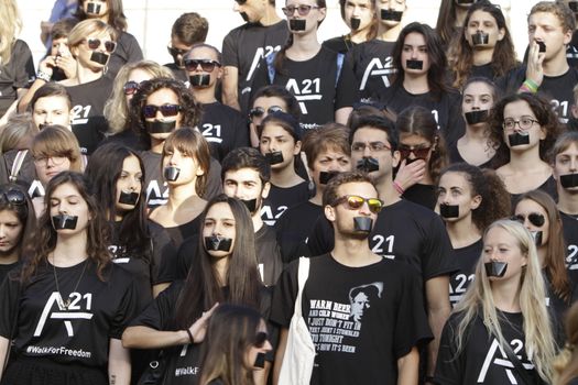 GREECE, Athens: Athens residents pose for a photo while participating in the Walk for Freedom, a global initiative against human trafficking by the A21 Campaign, on October 17, 2015. The walk was one of several held worldwide by the organisation, which aims to raise awareness of human trafficking and provide support to survivors.  		