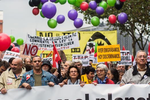 SPAIN, Madrid: Hundreds attend a protest against the Transatlantic Trade and Investment Partnership in Madrid, Spain on October 17, 2015. Leaders are still reaching an agreement on the TTIP, a deal designed to boost the US economy and European Union by removing tariffs and other barriers to trade and foreign investment. Protesters argue the TTIP will support corporations at the expense of citizens, increase poverty and inequality and harm the environment. 
