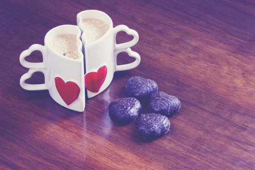 Two cups of coffee on old wooden table