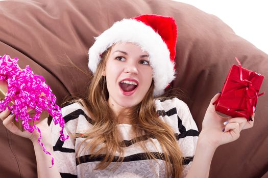 attractive girl sits on a chair with a gift in her hands