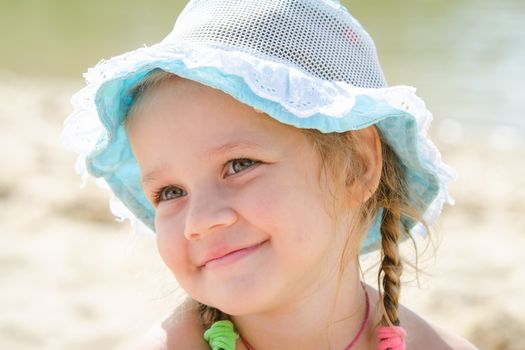 Close-up portrait of a happy girl Europeans in panama, located on the beach