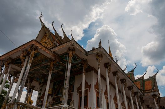 Roof of temple in Laos with blue sky and clouds in close to Luang Prabang