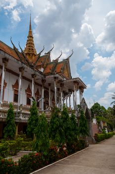Beautiful ancient temple in Laos with a path and plants in front