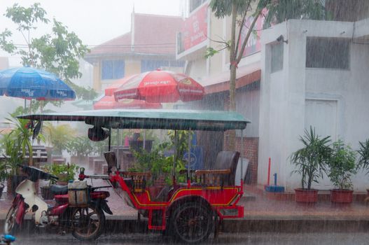 Tuktuk during rain monsoon in Kampot Cambodia