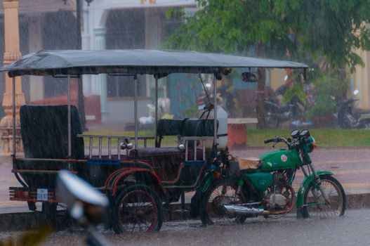 Tuktuk during rain monsoon in Kampot Cambodia
