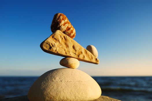 Well-balanced stack of pebbles on the shore