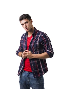 Serious looking young man wearing red t-shirt and casual shirt looking at camera isolated in white background