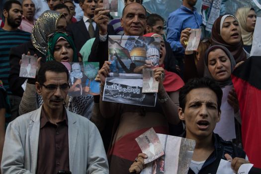 EGYPT, Cairo: Protesters gathered outside the Syndicate of Journalists building in Cairo, Egypt on October 18, 2015 in a show of support for Palestinians. The activists demonstrated against the recent attacks in Jerusalem, the West Bank and Gaza. They raised the flag of Palestine as some people stood on Israel's flag in anger.