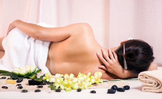 Young beautiful woman relaxing and enjoying at the spa center.