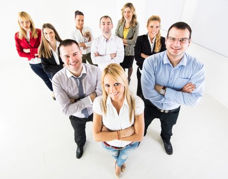 Group of a Successful Business People standing together with arm crossed and looking at the camera.