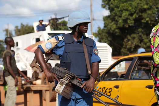 CENTRAL AFRICAN REPUBLIC, Bangui : Soldiers of the United Nations Multidimensional Stabilization Mission in Central African Republic, Minusca, passe on a street in Bangui, as they patrol in the city, on October 18, 2015. The Central African Republic descended into bloodshed more than two years ago after long time president Francois Bozize, a Christian, was ousted by Seleka rebels, triggering the worst crisis since independence in 1960. On September 29, 2015, Bangui returned to only relative calm after three days of inter-community violence which left at least 40 dead and 100 injured according to the UN Refugee Agency UNHCR. Some 27,000 inhabitants of Bangui have also fled to displaced people's camps