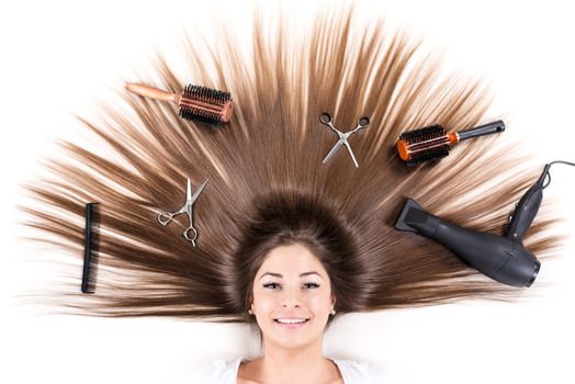 Cute young girl with Beautiful healthy shiny hair and Haircutting Equipment.