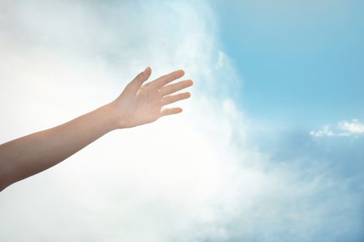 Human hand on a summer sky background