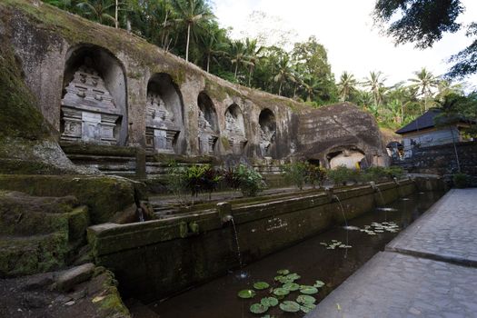 unung Kawi Temple. Gunug Kawi is an ancient temple situated in Pakerisan River, near Tampaksiring village in Bali. The archaeological complex is carved out of the living rock, dating to 11th century.