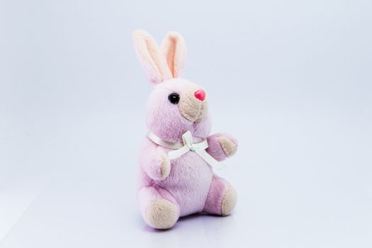 Funny knitted rabbit toy isolated on white background with soft shadow