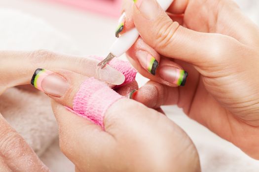 Manicure treatment in cosmetic saloon.