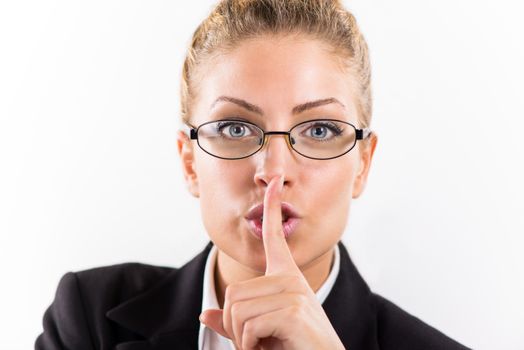 Portrait of attractive businesswoman with glasses showing shhh.