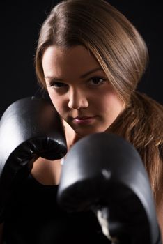 Portrait of Young beautiful boxing girl standing with a guard ready to punch. 