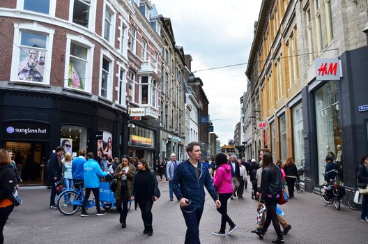 The Hague, Netherlands - May 8, 2015: People shopping on venestraat shopping street in The Hague, Netherlands. on  May 8, 2015. The Hague is the capital city of the province of South Netherlands. With a population of 515,880 inhabitants.