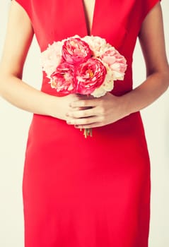 close up of woman hands with bouquet of flowers.