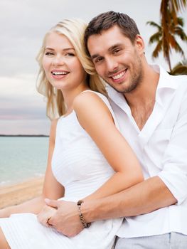 summer holiday, vacation, dating, travel and tourism concept - happy couple having fun and hugging over beach background