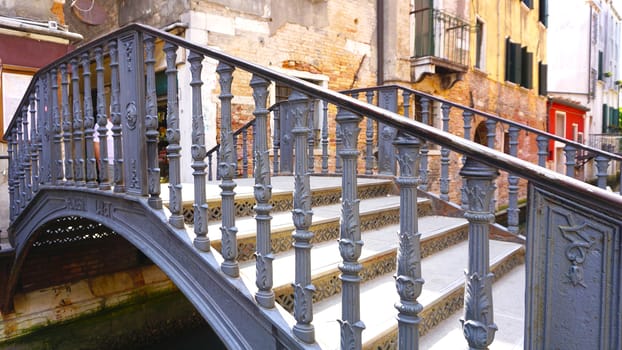 metal bridge cross canal in venice, italy