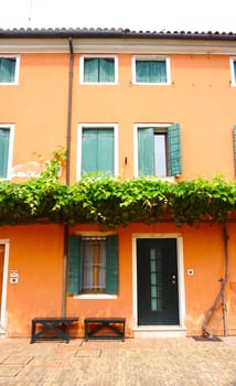 orange color house building in venice, italy