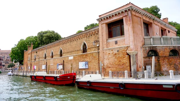 canal and boats with ancient architecture in Venice, Italy