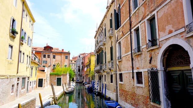 View of canal and boats with ancient architecture in Venice, Italy