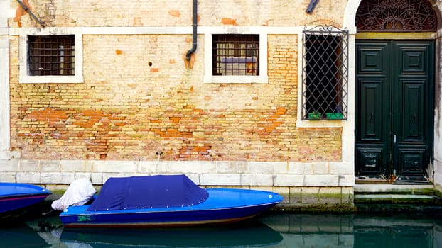 canal and boats with ancient buildings background in Venice, Italy