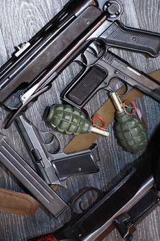 Terrorism equipment. Set of various firearm weapons and grenades on dark background