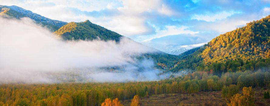 sunrise in autumn taiga and mountains