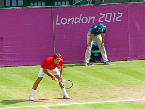 WIMBLEDON, ENGLAND - August 2nd, 2012 - Roger Federer during one of his singles matches at the summer Olympics in London in 2012. He came 2nd and won the silver medal in the tournament.