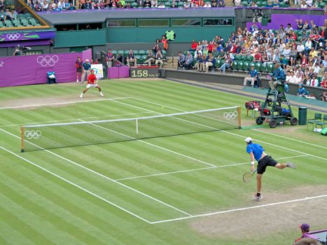 WIMBLEDON, ENGLAND - August 2nd, 2012 � Roger Federer and John Isner during their singles matches at the summer Olympics in London in 2012. Roger Federer came 2nd, silver medal and John Isner made it to the quarterfinals in the tournament