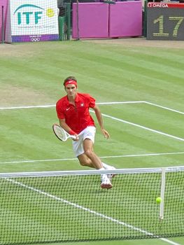 WIMBLEDON, ENGLAND - August 2nd, 2012 - Roger Federer during one of his singles matches at the summer Olympics in London in 2012. He came 2nd and won the silver medal in the tournament.