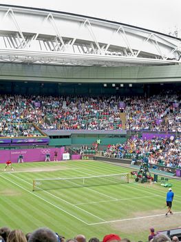 WIMBLEDON, ENGLAND - August 2nd, 2012 � Roger Federer and John Isner during their singles matches at the summer Olympics in London in 2012. Roger Federer came 2nd, silver medal and John Isner made it to the quarterfinals in the tournament