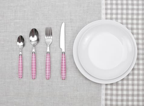 empty plate with fork, spoon and knife